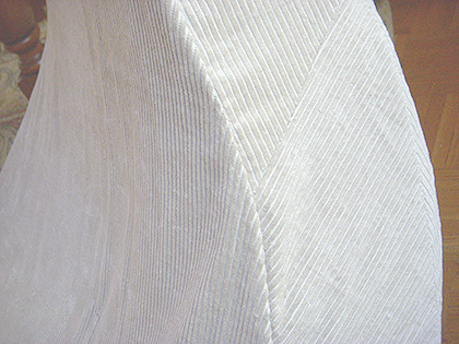The entire left side and the entire right side could have been cut as complete flat shapes. instead, the long shapes are divided into smaller segments. Of course, this allows full use of fabric scraps, but also permits play with nap direction. A fabric like corduroy especially lends itself to chevron shapes where the welts are sew together.